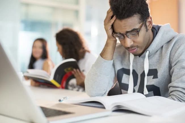 A stressed student studying late